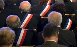 French Mayors, wearing their tri-colour scarves, listen to France's President Nicolas Sarkozy (not pictured) as he delivers a speech at the Elysee Palace in Paris , FRANCE-20/11/2009